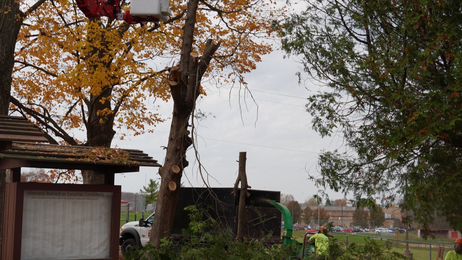 An Ole Man RB's crane lifting a large tree section over a West Michigan home